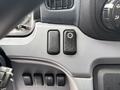 Dashboard control panel of a 2015 Mitsubishi Fuso FE160 featuring two buttons one is black and the other has a gear icon