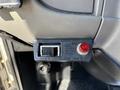 Close-up of a Chelsea PTO engagement switch and indicator light located on the dashboard of a 2015 Peterbilt 337 truck