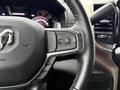 Close-up of the steering wheel of a 2024 RAM 5500 featuring control buttons for cruise settings and gear limit