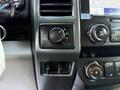 Dashboard controls of a 2020 Ford F-350 SD including a four-wheel drive selector and audio system knobs