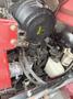 Close-up of the engine compartment of a 2013 Toro Grounds Master 5910 featuring various hoses cables and components including an air filter and fluid reservoir
