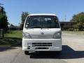 A white 2009 Daihatsu Hijet facing forward with a simple design featuring a rectangular grille and large headlights