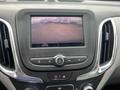 A dashboard display of a 2022 Chevrolet Equinox showing a rearview camera view with orange guidelines