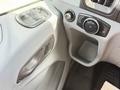 Interior detail of a 2016 Ford Transit showing the door handle and window control panel along with a control knob for exterior lights