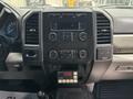 Dashboard of a 2017 Ford F-550 featuring control buttons a digital clock and an audio system display