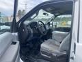 Interior view of a 2014 Ford F-350 SD showing the driver's seat dashboard and steering wheel with a gear shift and center console visible