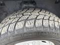 Close-up of a tire on a 2016 RAM 1500 showcasing a rugged tread pattern and visible dirt accumulation on the surface