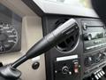A close-up of the gear shift lever in a 2008 Ford F-450 SD with a knob labeled TOW/HAUL and various control buttons surrounding it
