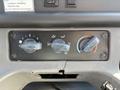 Control panel with three knobs for air conditioning and heating settings in a 2006 Freightliner M2 106