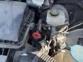 Close-up of a 2016 Mercedes-Benz Sprinter's engine compartment showing various components including the battery and fluid reservoirs