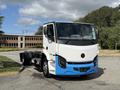 A 2022 Lion Lion6 electric truck with a white and blue exterior design is prominently displayed in the foreground