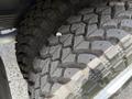 Close-up view of a rugged tire with deep tread patterns on a 2018 Ford E-450 showcasing its durability and grip