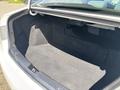 A 2014 Hyundai Sonata with an empty trunk showcasing its spacious interior and dark carpeting