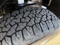 Close-up of a tire tread on a 2023 Mercedes-Benz Sprinter 2500 showcasing deep grooves and a rugged design for enhanced traction and durability