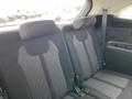 The interior of a 2022 Kia Sorento showing the back seats with fabric upholstery and seating for three passengers