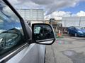 2018 Chevrolet Colorado showing the side mirror with a reflection of the surrounding area and vehicles in the background