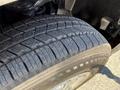 Close-up of a treaded tire from a 2014 Ford F-150 showcasing the robust design for traction and durability
