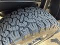 Close-up of a rugged tire tread from a 2021 Jeep Wrangler showcasing deep grooves and a sturdy design for off-road performance