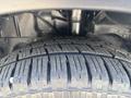 Close-up of a tire from a 2019 Ford Transit 350 showcasing deep tread patterns and textured rubber surface
