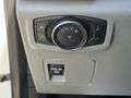 A control panel in a 2018 Ford F-150 featuring a dial for headlights and fog lights along with a pull switch for additional functions