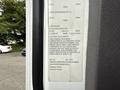 A 2021 Freightliner M2 106 truck with a detailed specifications label showing tire and vehicle information