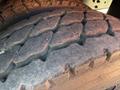 Close-up of a worn tire tread on a 2013 International CE300 revealing deep grooves and signs of use
