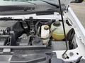 A close-up view of the engine compartment of a 2022 Ford E-450 showing the engine components and fluid reservoirs