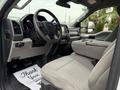 Interior of a 2020 Ford F-550 featuring a steering wheel seats and dashboard with a thank you mat on the floor