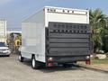 A white 2008 Ford Econoline box truck with a foldable rear gate designed for loading and unloading cargo