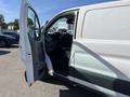 A 2017 Ford Transit van with the driver's side door open displaying the interior and steering wheel