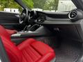 Interior of a 2023 Alfa Romeo Giulia featuring sporty red leather seats and a modern dashboard with a central console and air vents