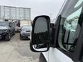 Close-up of the side mirror of a 2020 RAM Promaster showing its angular design and reflective surface