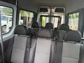 Interior view of a 2009 Dodge Sprinter Van showing five seats with seat belts and a partition behind the front seats