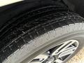 Close-up of a black tire with an intricate tread pattern mounted on a 2018 Toyota 4Runner wheel