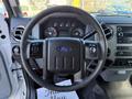Steering wheel of a 2010 Ford F-450 with controls and dashboard gauges visible in the background