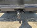 A 2022 Ford F-350 SD rear hitch with a ball mount and electrical connector visible in the foreground