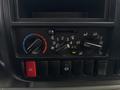 Control panel of a 2018 Hino 195 featuring dials for air conditioning fan speed temperature and airflow direction along with various switches for vehicle functions