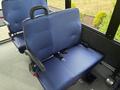 A blue fabric seat with armrests and a seatbelt designed for a 2020 Chevrolet Express