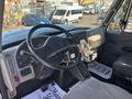 Interior view of a 2013 International 7500 truck showing the dashboard steering wheel and driver controls