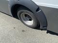 2020 Chevrolet Express with a close-up view of the front tire and fender showing the tire tread and wheel design
