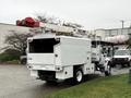 A white 2020 International MV607 truck with a mounted aerial lift and a closed utility body at the rear