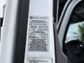A label displaying certification information for a 2015 Freightliner M2 including inspection details and vehicle identification number