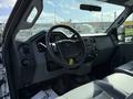 Interior view of a 2011 Ford F-250 SD showing the dashboard steering wheel and center console