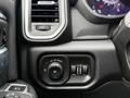 The interior controls of a 2024 RAM 5500 featuring knobs for headlights and climate settings along with air vents and instrument cluster displays