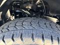 A close-up view of a tire on a 2019 Ford F-150 showcasing the tread pattern and a portion of the vehicle's suspension components