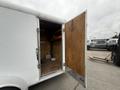 A 2016 Continental cargo trailer with an open door revealing a wooden interior and lighting fixtures inside