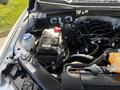 Close-up of the engine bay of a 2018 Ford F-150 showing the battery and various components with pipes and wires connected