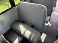 A gray seat with seat belts designed for a 2011 Freightliner B2 bus