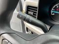 Close-up of the turn signal and headlight control stalk on the steering column of a 2023 Ford F-450 Super Duty