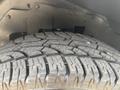 Close-up of a heavily treaded tire from a 2021 Chevrolet Express showing detailed grooves and patterns designed for traction and grip
